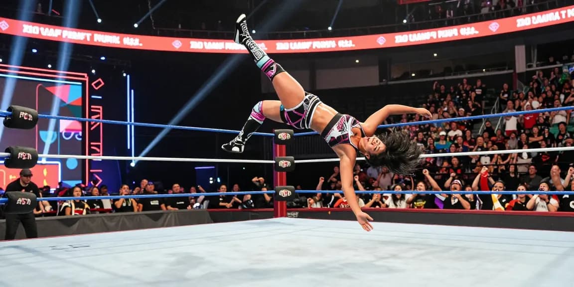 Roxanne Perez executing a stunning wrestling move in the ring, showcasing her skills and athleticism amid an energetic crowd.